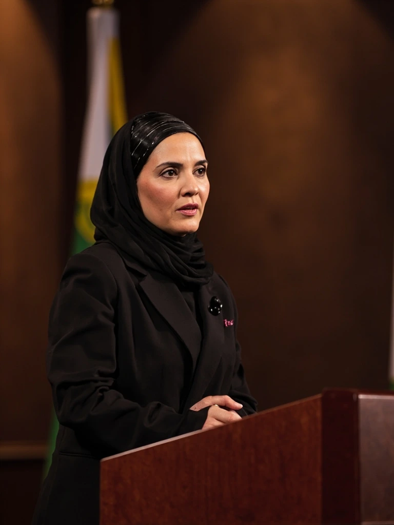 A Gulf woman parliamentarian at a policy podium